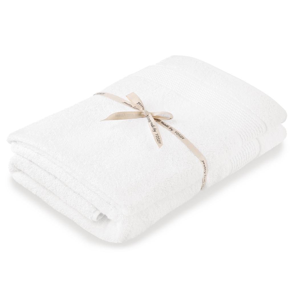 Biały ręcznik dziecięcy z kokardką, idealny na prezent dla niemowląt.